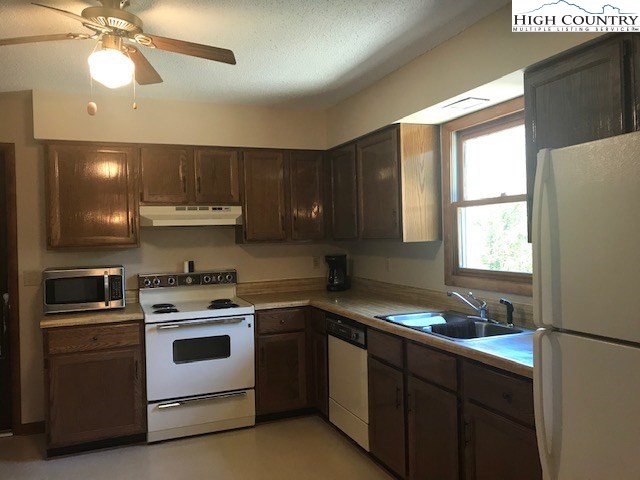 1307 Ben Miller Road Deep Gap, NC 28618 - Photo 10 of 26 a kitchen with a stove a sink and a window