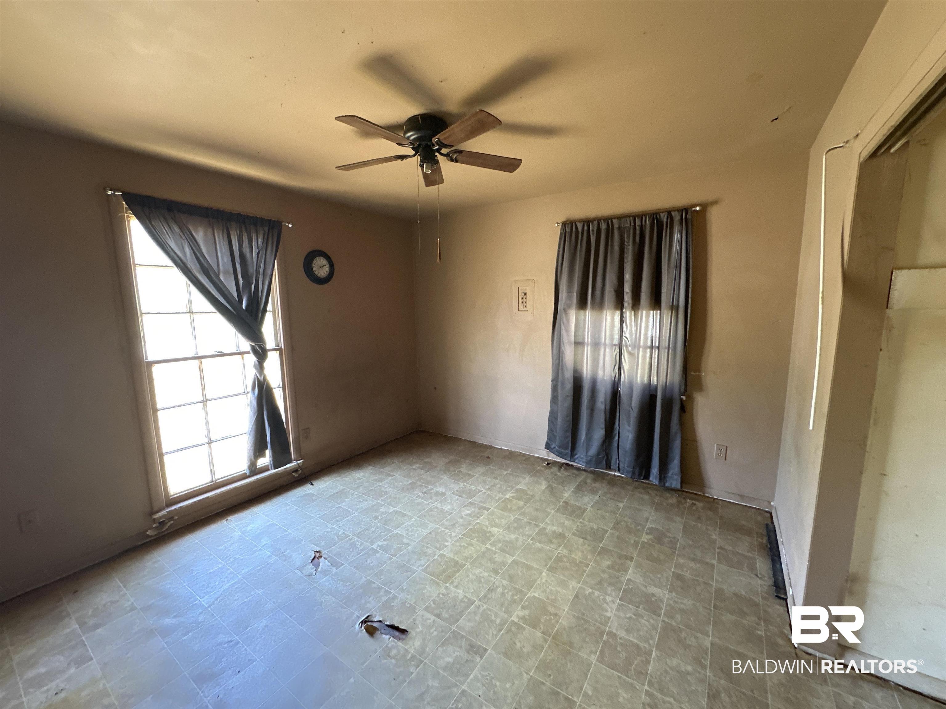 58 Chieftain Way Mobile, AL 36611 - Photo 4 of 12 Tiled empty room featuring ceiling fan