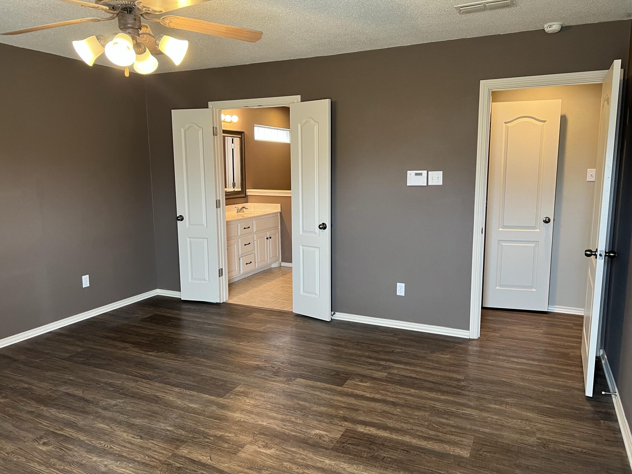 5027 Itasca Street Lubbock, TX 79416 - Photo 11 of 22 a view of an empty room with wooden floor and a window