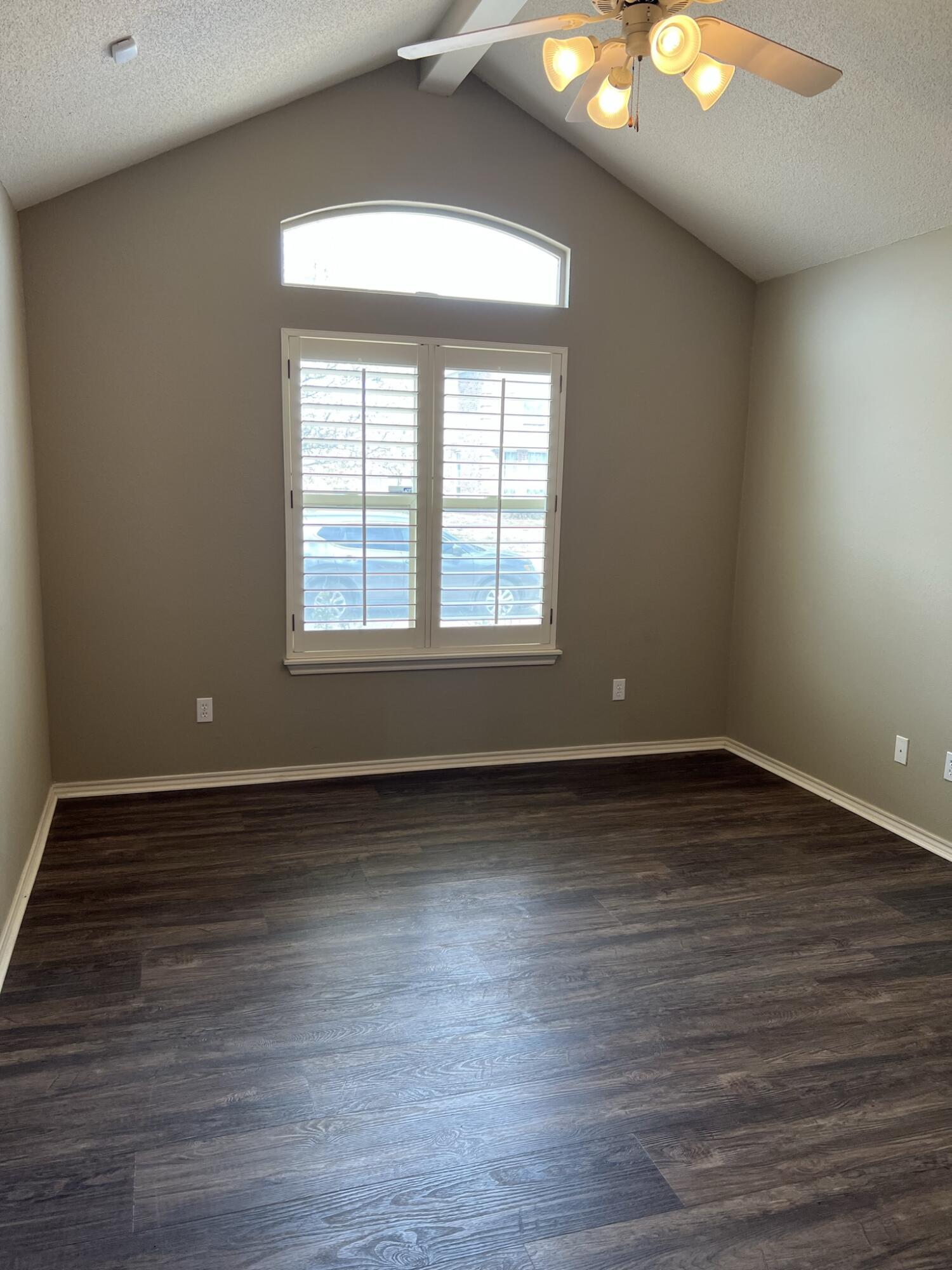 5027 Itasca Street Lubbock, TX 79416 - Photo 14 of 22 an empty room with wooden floor and windows