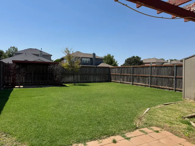 a view of a backyard with a garden and deck