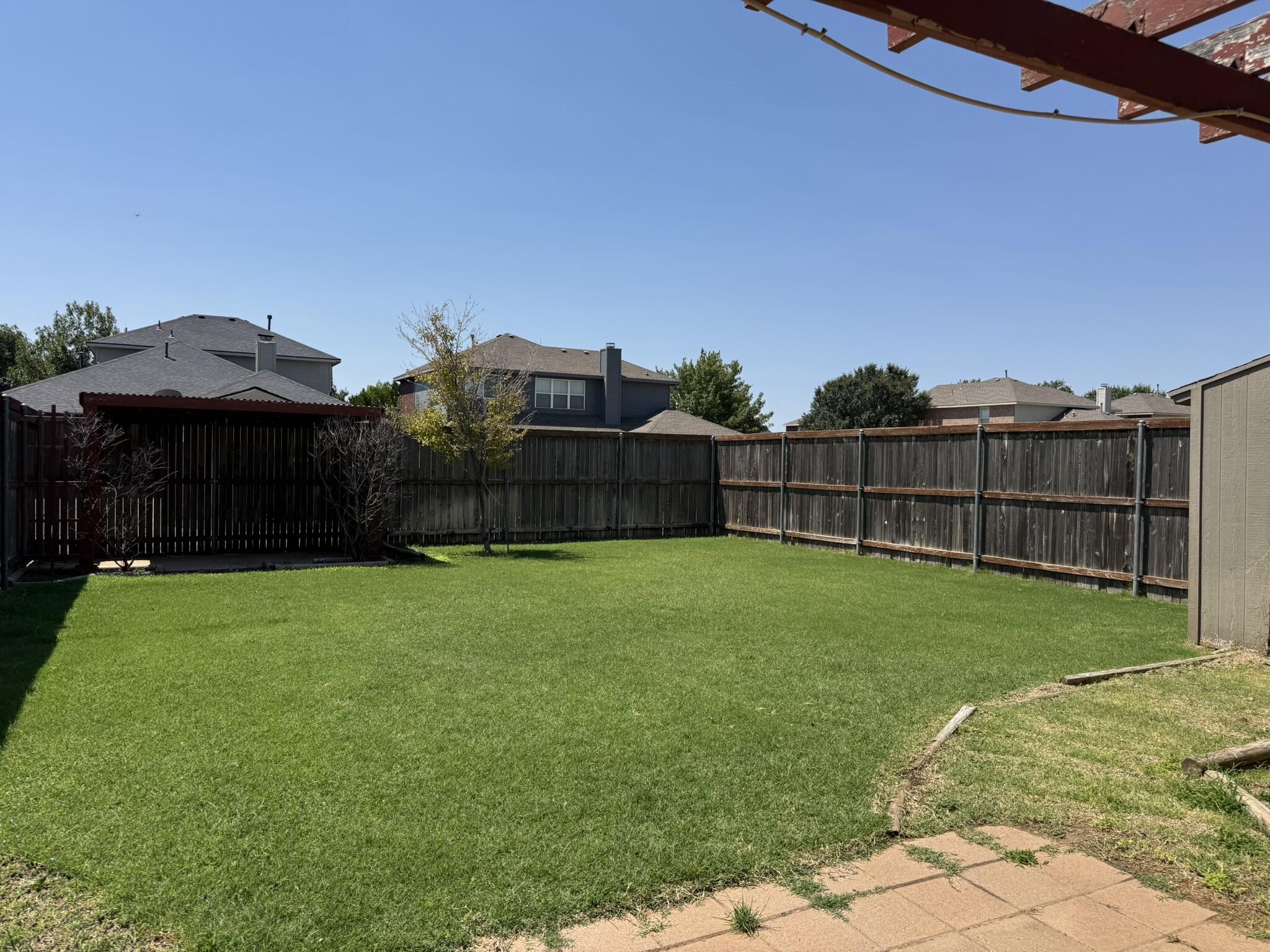5027 Itasca Street Lubbock, TX 79416 - Photo 20 of 22 a view of a backyard with a garden and deck