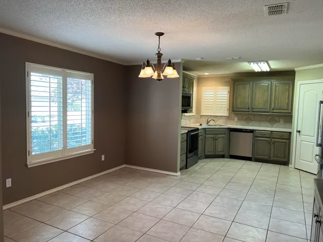 a kitchen with a sink cabinets and window