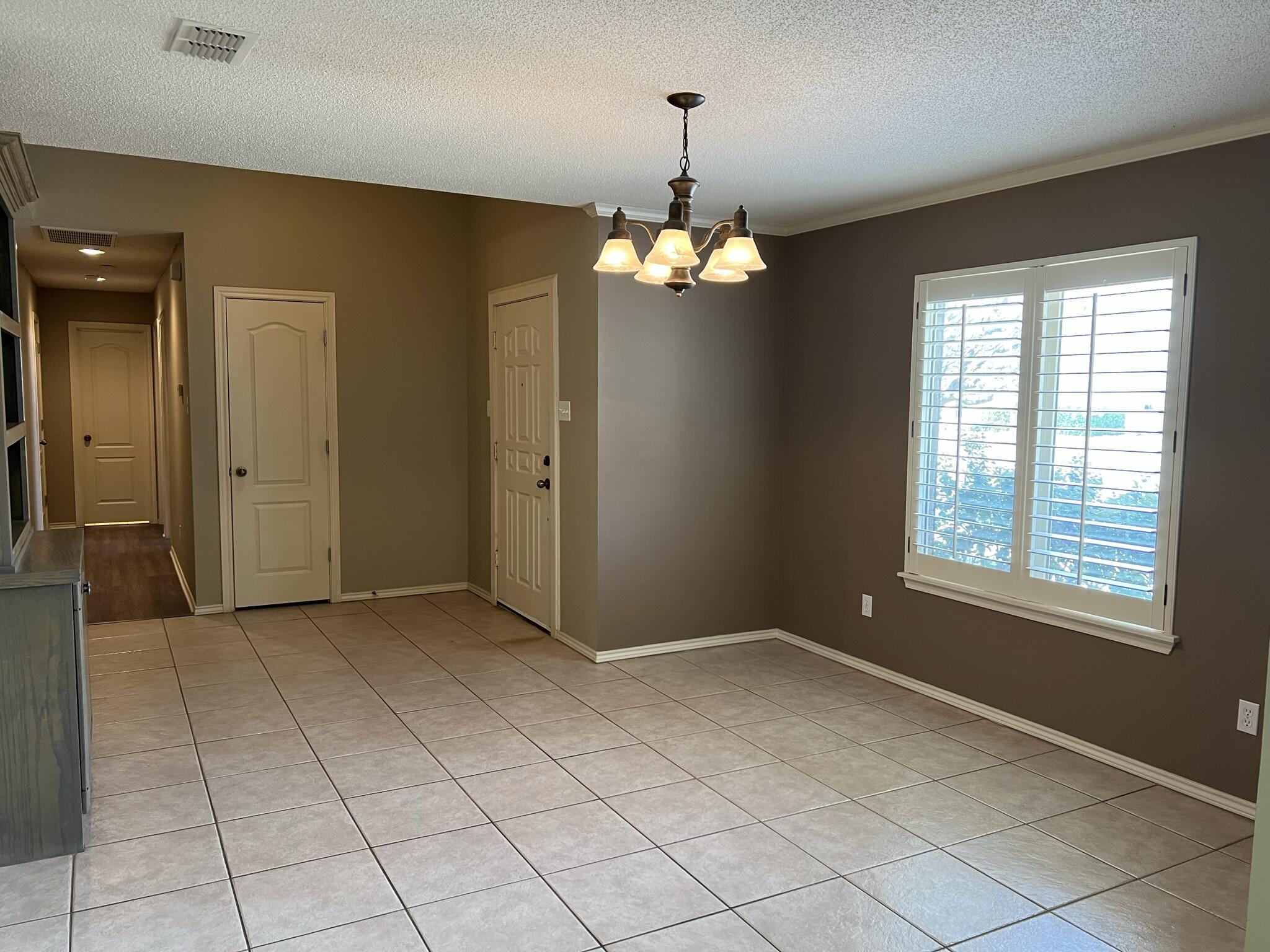 5027 Itasca Street Lubbock, TX 79416 - Photo 9 of 22 wooden floor in an empty room with a window