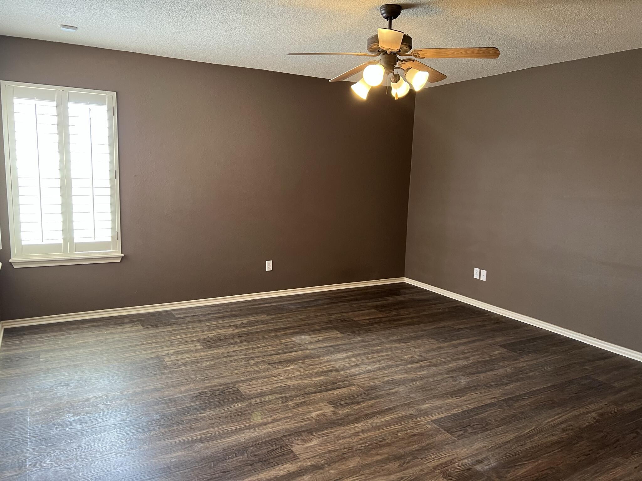 5027 Itasca Street Lubbock, TX 79416 - Photo 10 of 22 a view of a room with wooden floor and a window