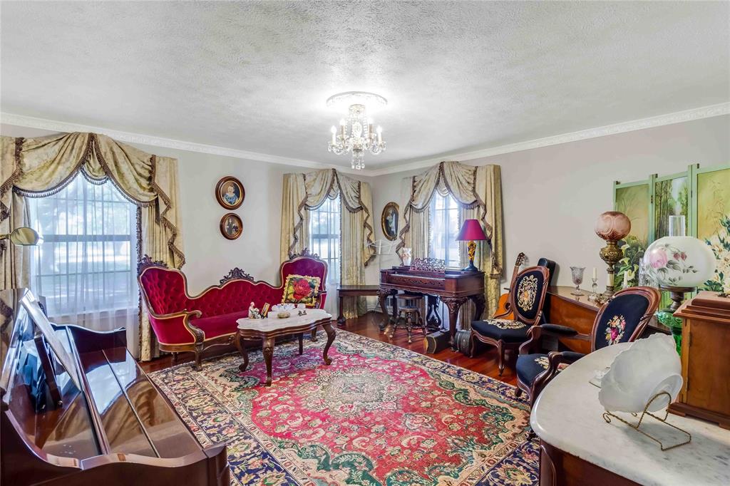 216 McMillen Road Lucas, TX 75002 - Photo 9 of 36 a living room with furniture a rug and a chandelier
