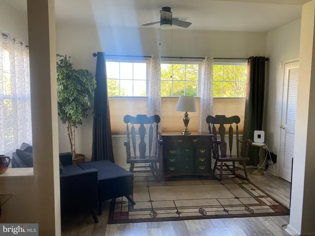 a view of a workspace with furniture and a window