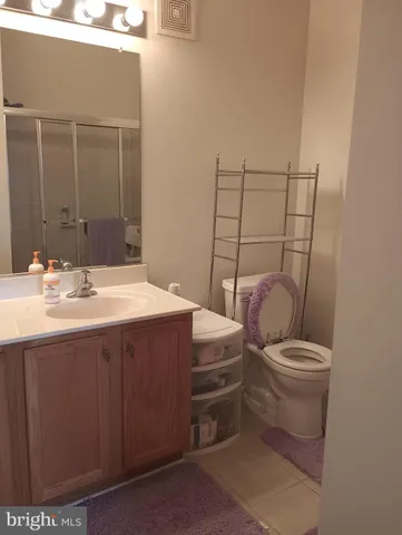 a bathroom with a sink a toilet and mirror