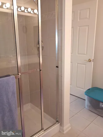 a bathroom with a glass shower door