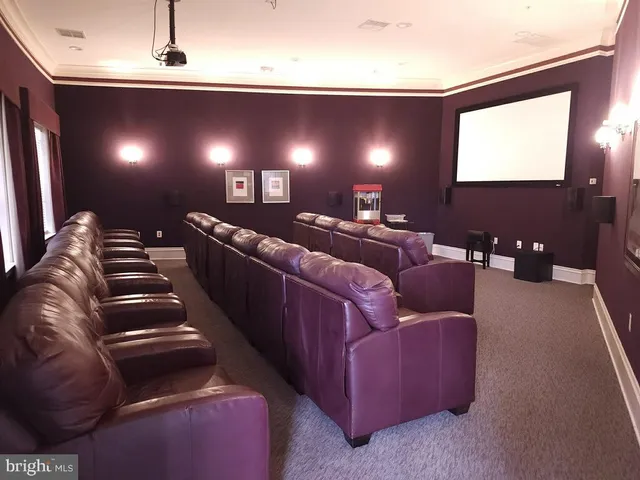 a media room with lots of chairs and a projector