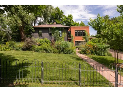 a view of an house with backyard space and garden