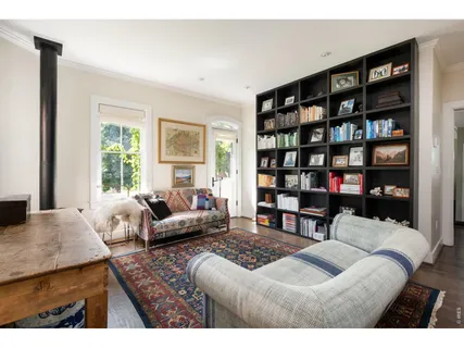 a living room with furniture and a book shelf