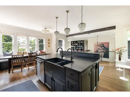 a kitchen with counter space sink stove and chairs