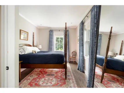 a bedroom with furniture and a rug