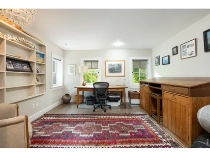 a living room with furniture rug and window