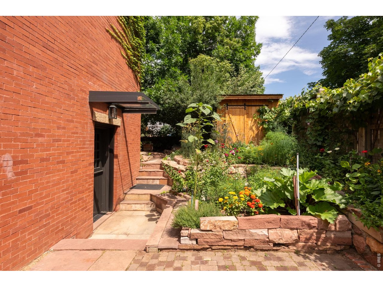 615 Spruce Street Boulder, CO 80302 - Photo 36 of 49 a front view of a house with a yard and potted plants