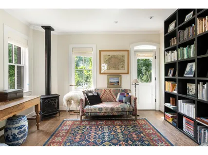 a living room with furniture and a book shelf