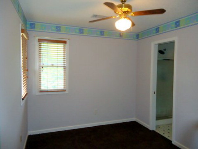 3090 Hamlin Road Lizella, GA 31052 - Photo 11 of 18 a view of an empty room with window and wooden floor