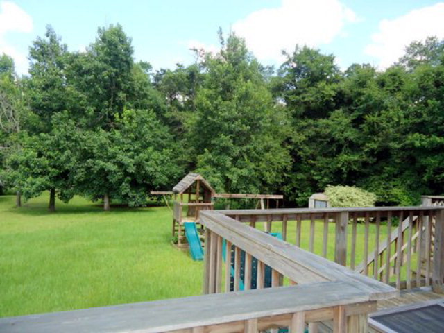 3090 Hamlin Road Lizella, GA 31052 - Photo 15 of 18 a view of a deck and backyard with green space