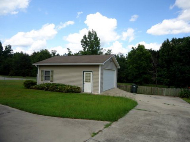 3090 Hamlin Road Lizella, GA 31052 - Photo 16 of 18 a front view of a house with a garden