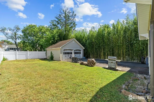 a view of a house with backyard and sitting area