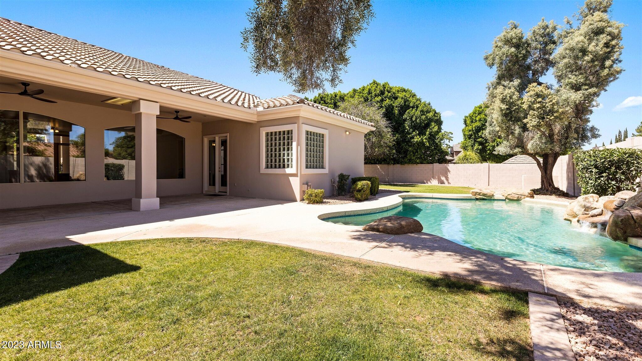155 North Riata Street Gilbert, AZ 85234 - Photo 52 of 63 Pool, Grass & Trees