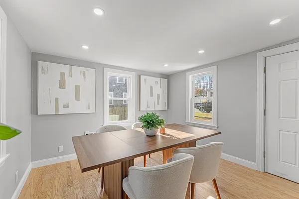 a view of a dining room with furniture window and wooden floor