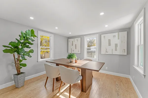 a dining room with furniture and wooden floor