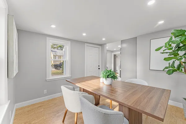 a view of a dining room with furniture and wooden floor