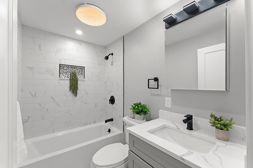 7 Webster Street Randolph, MA 02368 - Photo 14 of 32 a bathroom with a sink and bathtub