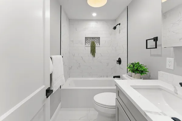 a bathroom with a sink toilet and bathtub