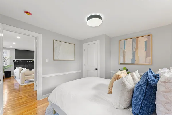 a bedroom with a bed and wooden floor