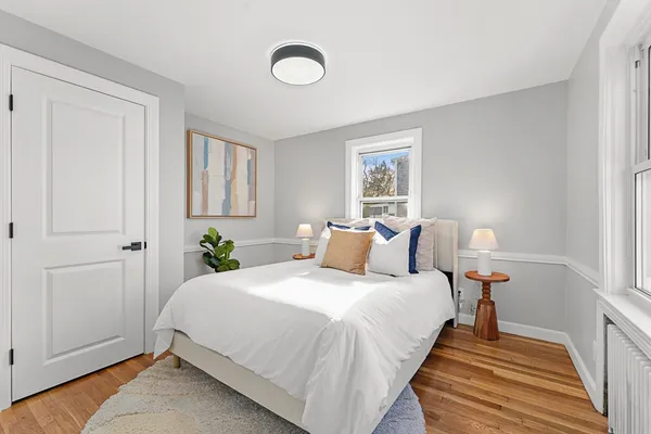 a bedroom with bed and window