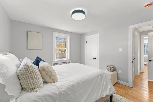 a bedroom with a bed and wooden floor