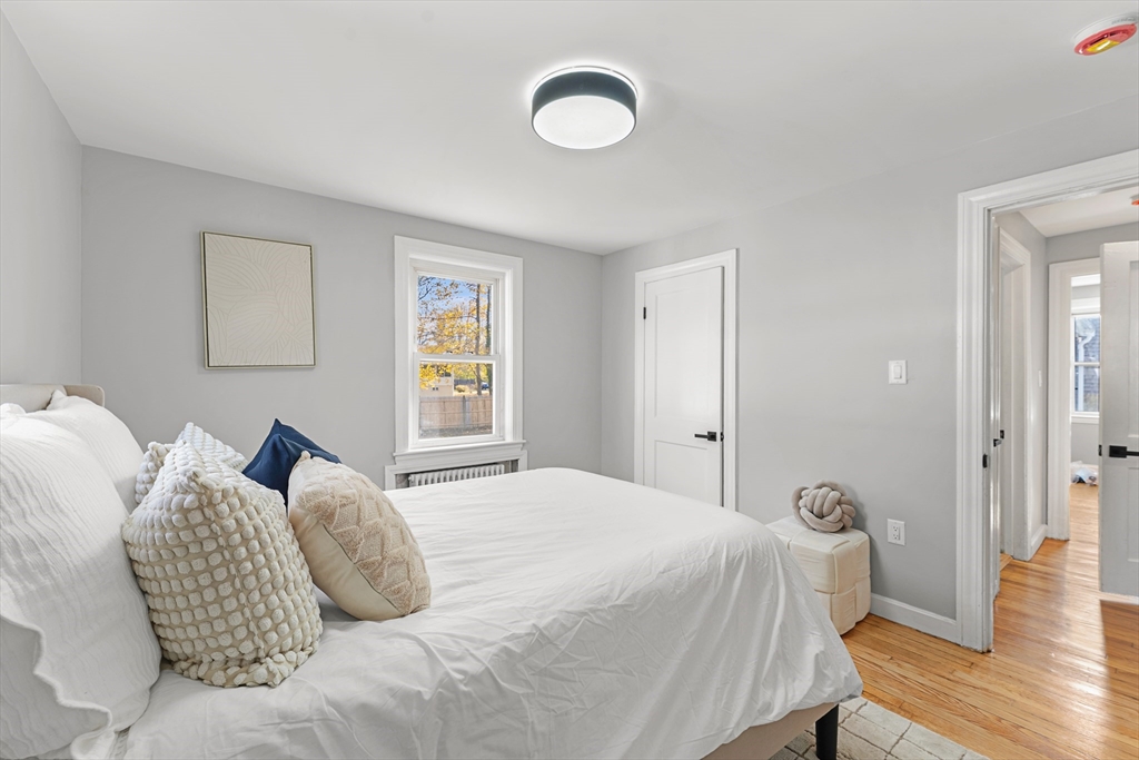 7 Webster Street Randolph, MA 02368 - Photo 20 of 32 a bedroom with a bed and wooden floor