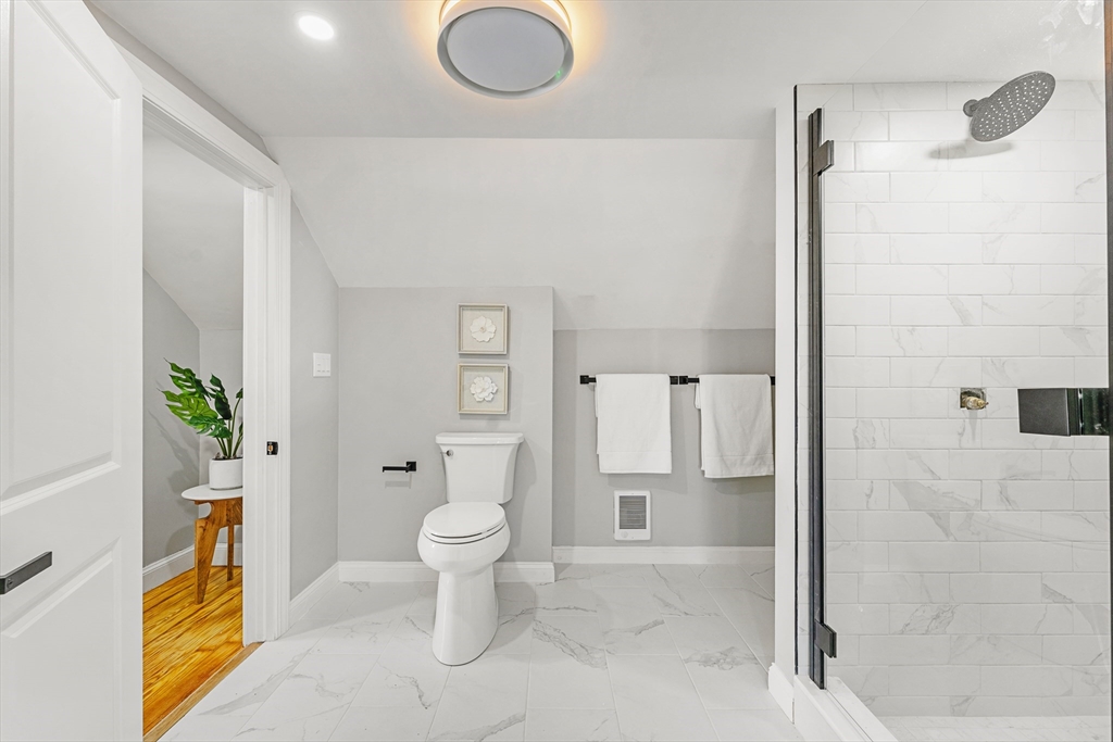 7 Webster Street Randolph, MA 02368 - Photo 21 of 32 a bathroom with a granite countertop sink a toilet and shower