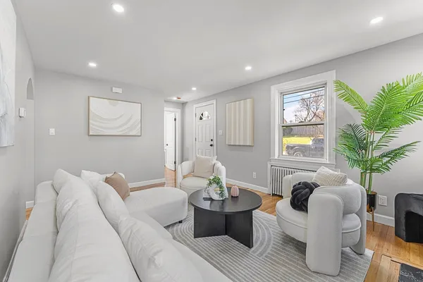 a living room with furniture and a potted plant