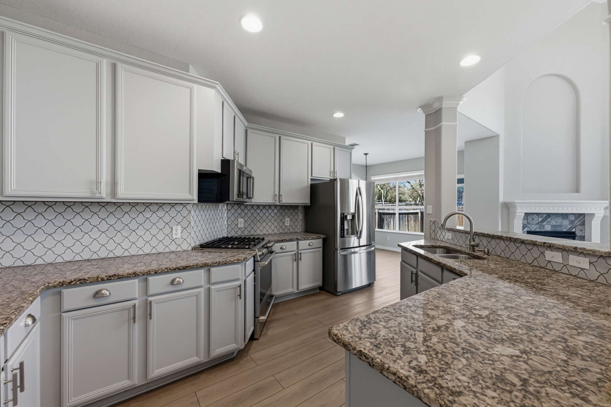 6810 Poncha Pass Austin, TX 78736 - Photo 15 of 35 a kitchen with stainless steel appliances granite countertop a sink stove microwave and refrigerator
