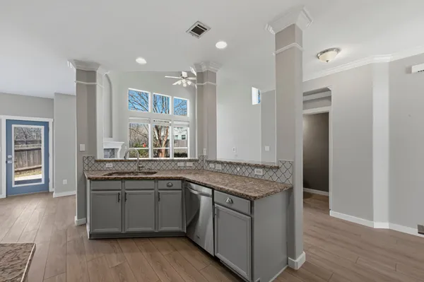a kitchen with a sink stove and cabinets