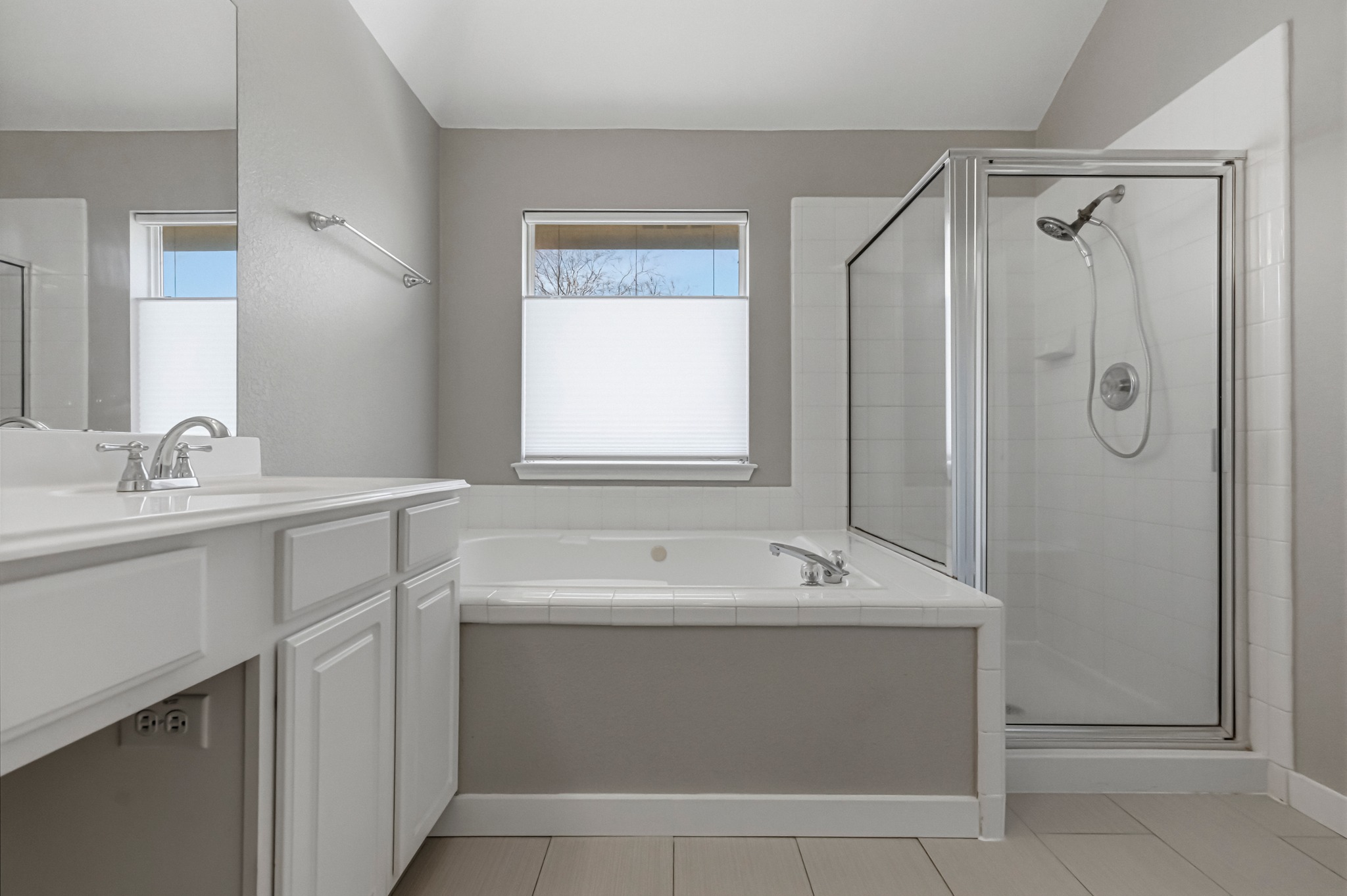 6810 Poncha Pass Austin, TX 78736 - Photo 26 of 35 a bathroom with a sink a mirror and a shower