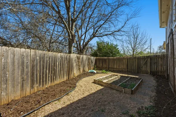 a garden view with wooden fence