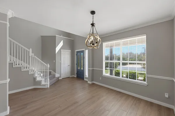 a view of an entryway with wooden floor
