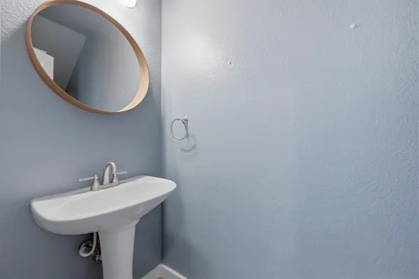 a bathroom with a sink and mirror