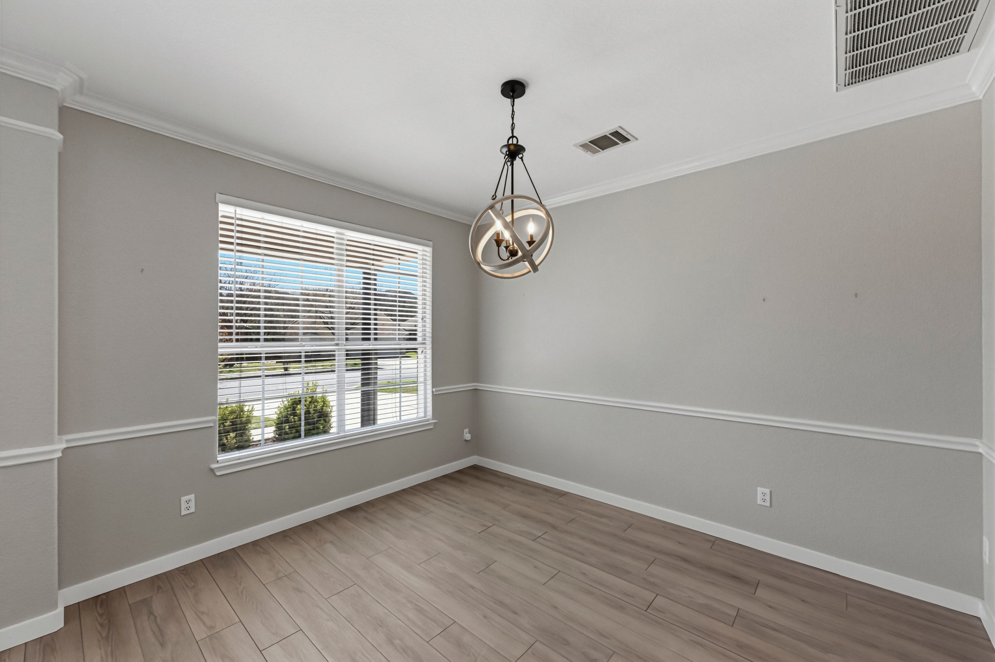 6810 Poncha Pass Austin, TX 78736 - Photo 8 of 35 a view of an empty room with wooden floor and windows