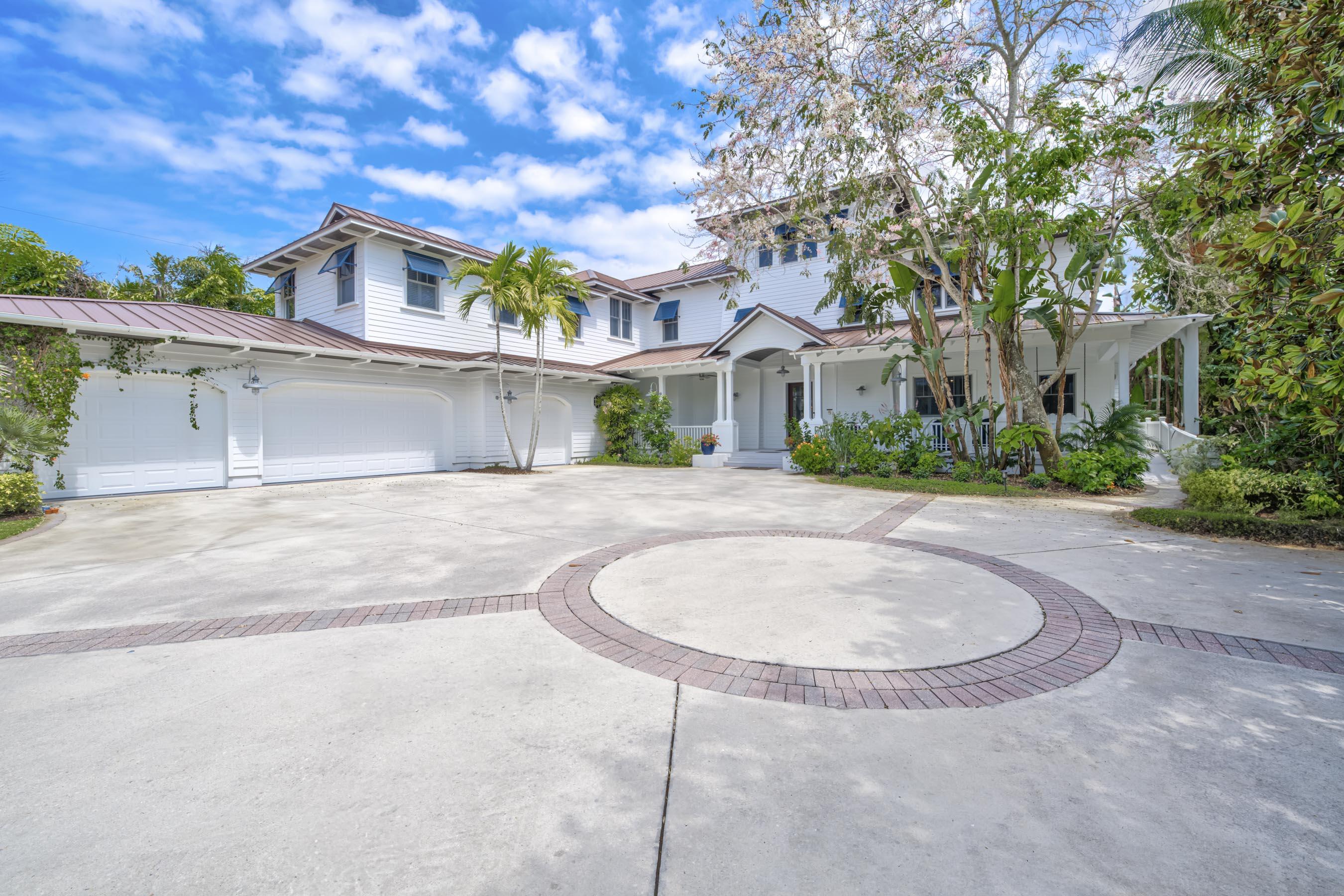 5270 Pennock Point Road Jupiter, FL 33458 - Photo 2 of 60 a view of a white house with a swimming pool and a yard
