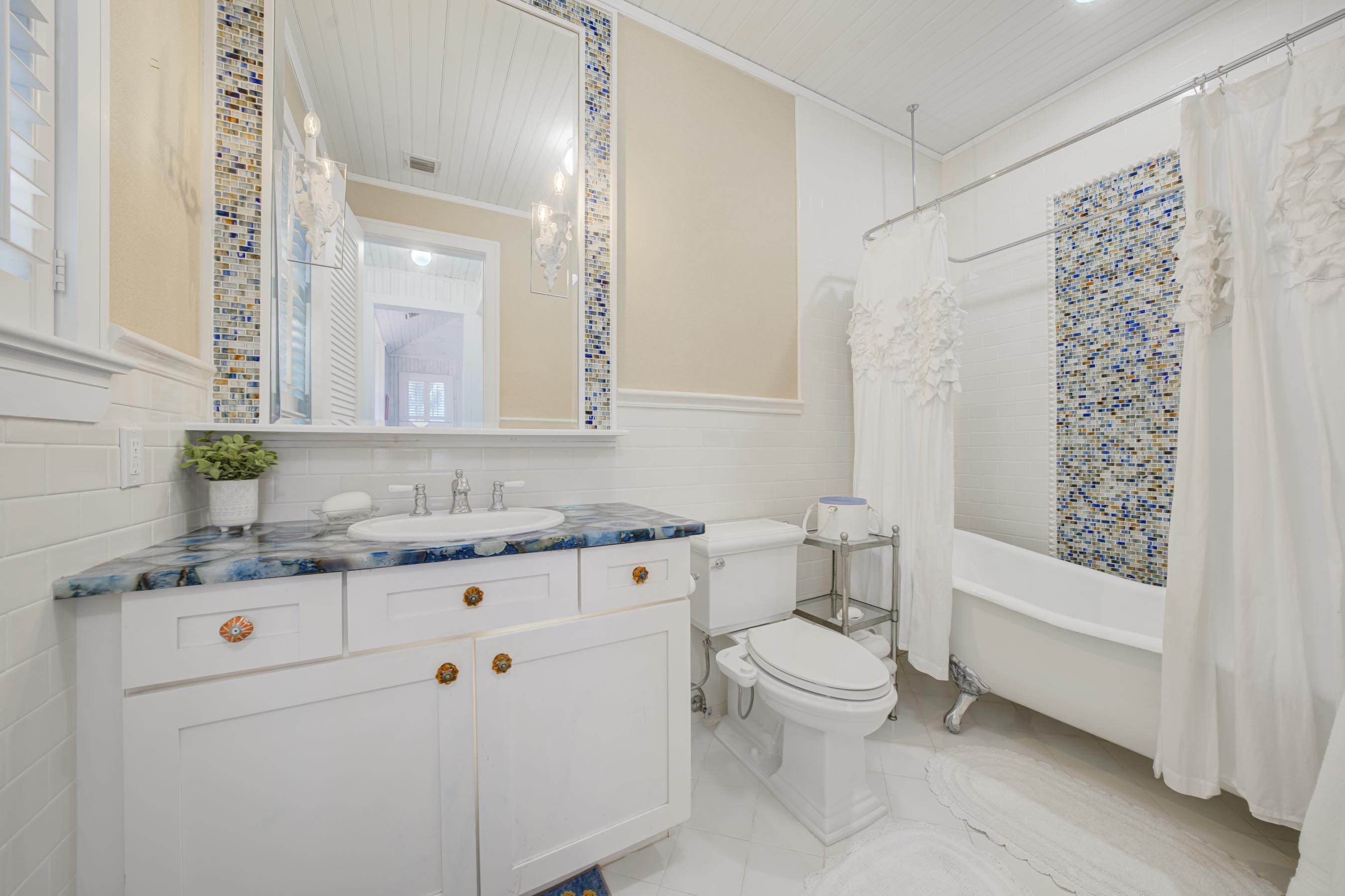 5270 Pennock Point Road Jupiter, FL 33458 - Photo 39 of 60 a bathroom with a granite countertop sink a toilet and a mirror