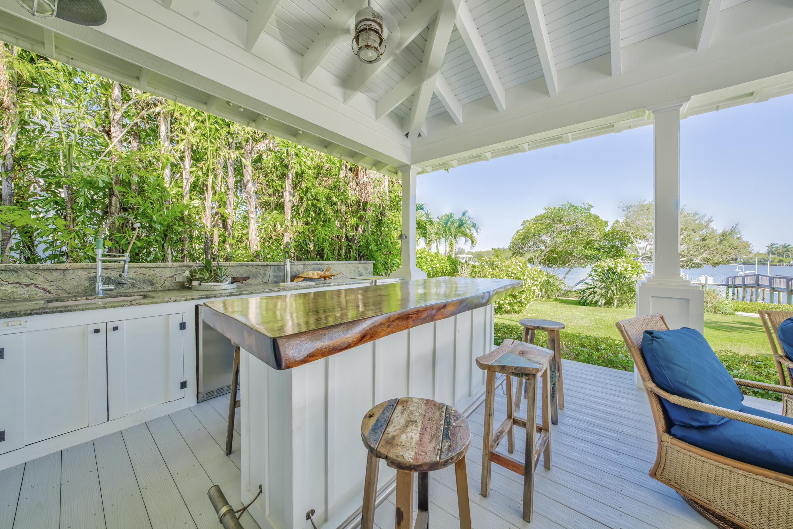 5270 Pennock Point Road Jupiter, FL 33458 - Photo 48 of 60 a kitchen with a table chairs sink and outdoor view