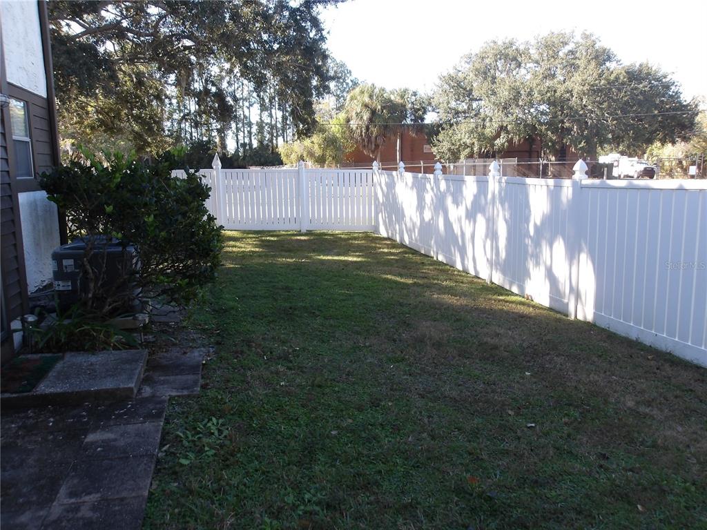 4140 Passport Lane, Unit 101 New Port Richey, FL 34653 - Photo 20 of 40 a backyard of a house with lots of green space
