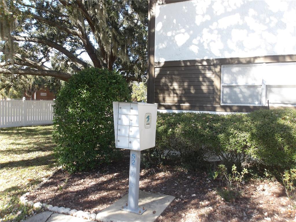 4140 Passport Lane, Unit 101 New Port Richey, FL 34653 - Photo 32 of 40 a street sign on a sidewalk next to a road
