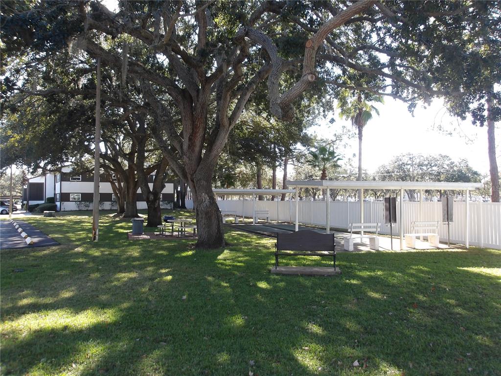 4140 Passport Lane, Unit 101 New Port Richey, FL 34653 - Photo 34 of 40 a view of a house with a backyard porch and sitting area